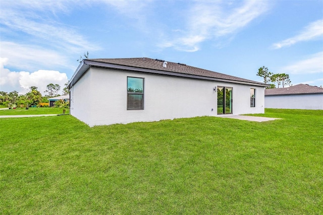 back of property with a patio area and a lawn