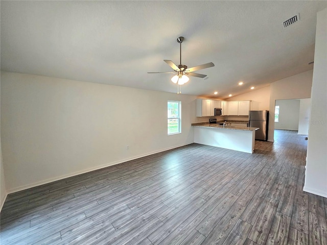 unfurnished living room with lofted ceiling, ceiling fan, and hardwood / wood-style flooring