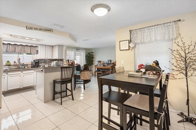 dining area with a wealth of natural light and light tile floors