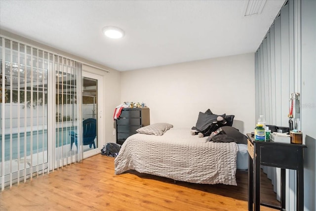 bedroom featuring light wood-type flooring and access to outside