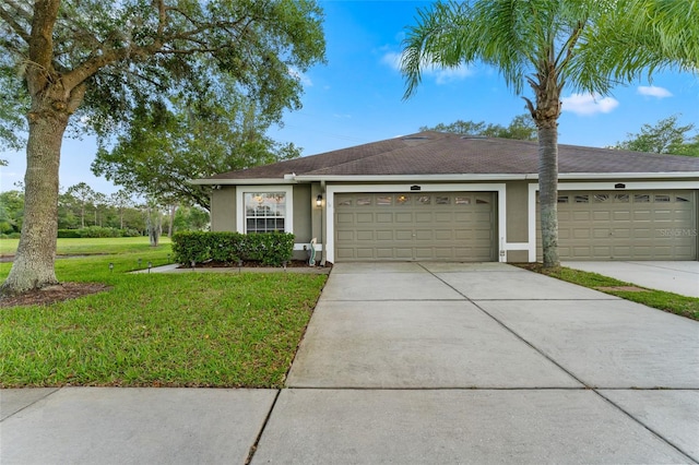 ranch-style home featuring a garage and a front yard