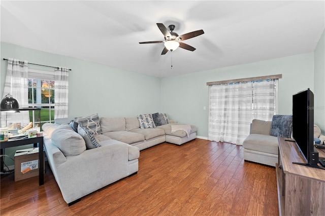 living room featuring ceiling fan and hardwood / wood-style flooring