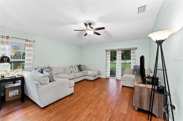 living room with ceiling fan and dark hardwood / wood-style floors