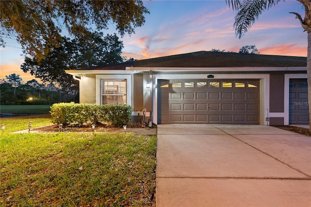 view of front of property with a yard and a garage