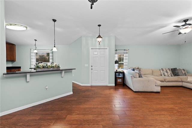 unfurnished living room with dark hardwood / wood-style floors and ceiling fan