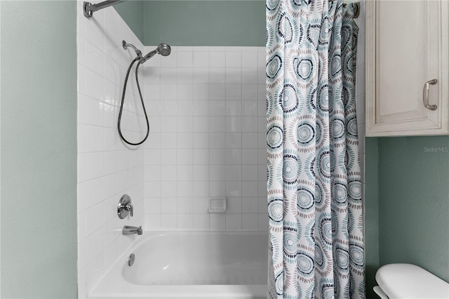 bathroom featuring shower / bath combo and toilet