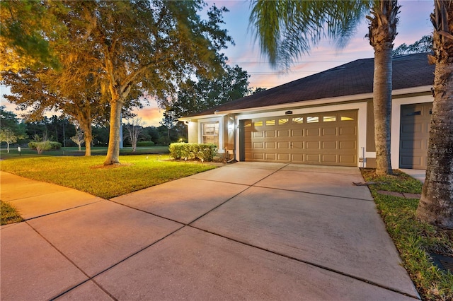 view of front of house with a yard and a garage