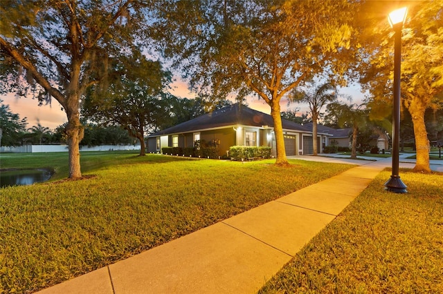 ranch-style home featuring a lawn