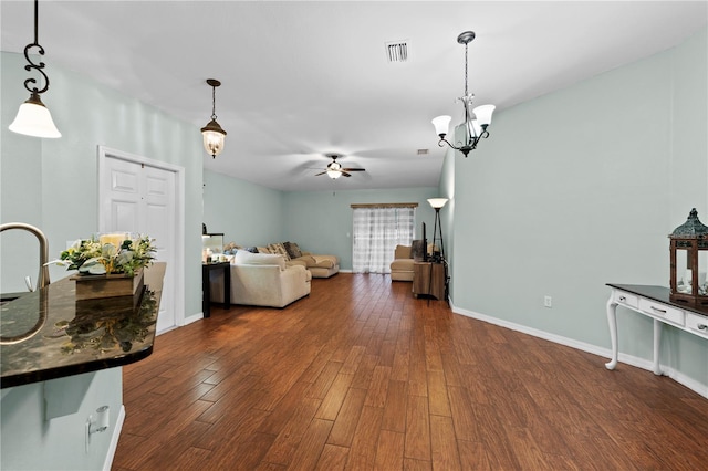 living room with sink, ceiling fan with notable chandelier, and dark hardwood / wood-style floors