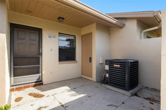 view of exterior entry with central AC unit