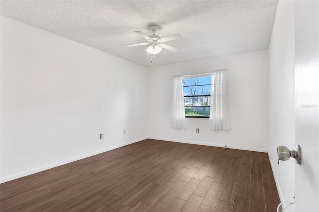 empty room featuring dark hardwood / wood-style flooring, ceiling fan, and a textured ceiling