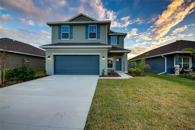 front facade with a garage and a lawn