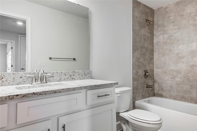 full bathroom featuring vanity, toilet, and tiled shower / bath combo