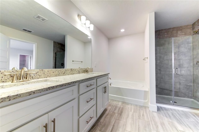 bathroom featuring vanity and shower with separate bathtub