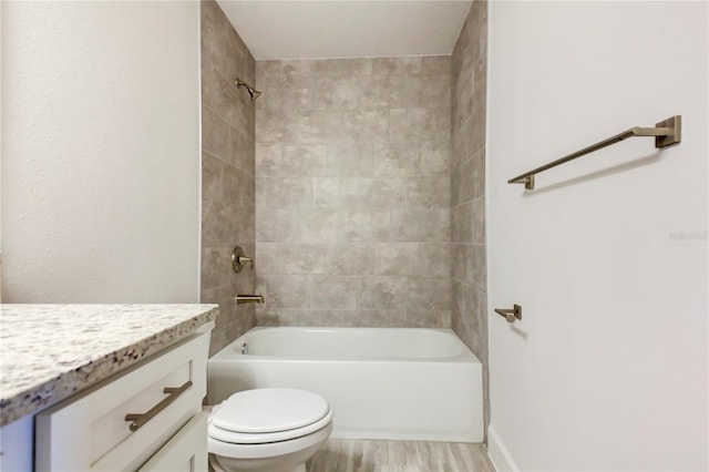 full bathroom featuring tiled shower / bath combo, vanity, wood-type flooring, and toilet