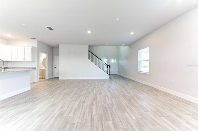 unfurnished living room with light wood-type flooring