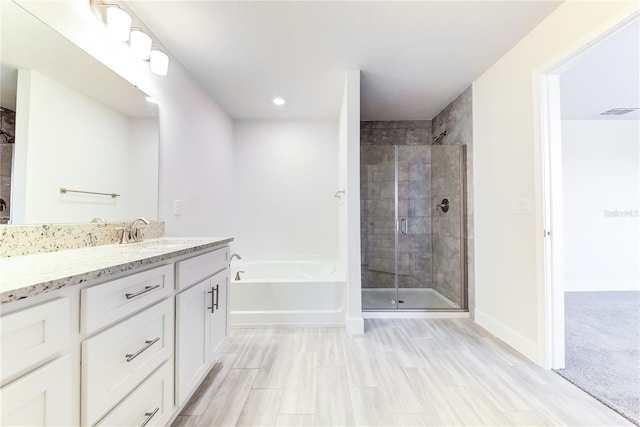 bathroom featuring independent shower and bath and vanity