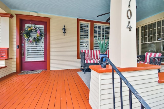 wooden terrace featuring ceiling fan and a porch