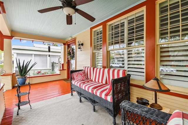 sunroom / solarium featuring ceiling fan