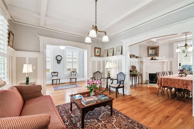 living room with hardwood / wood-style flooring, coffered ceiling, and beam ceiling