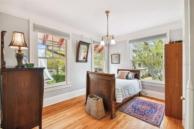 bedroom featuring multiple windows and light hardwood / wood-style floors