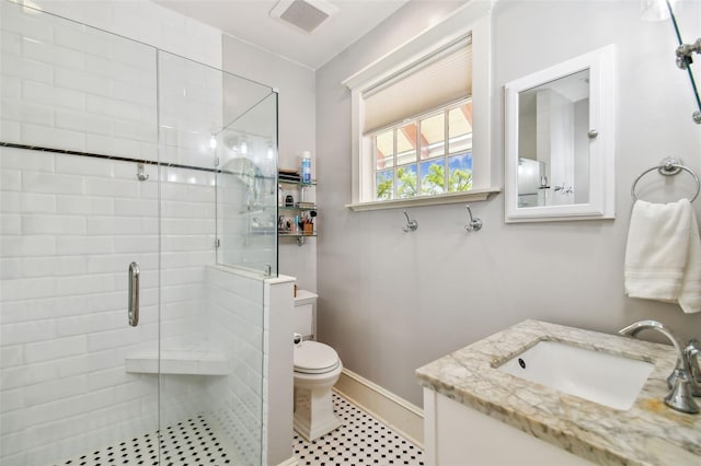 bathroom with walk in shower, vanity, and toilet