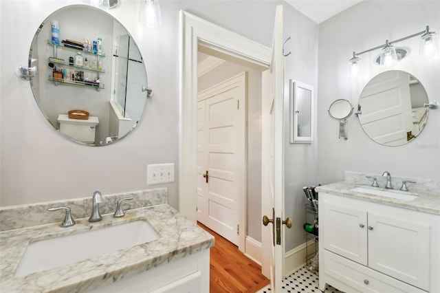 bathroom featuring vanity, toilet, and hardwood / wood-style floors