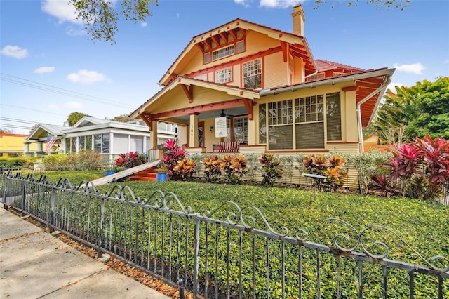 view of front of home with a front yard and covered porch