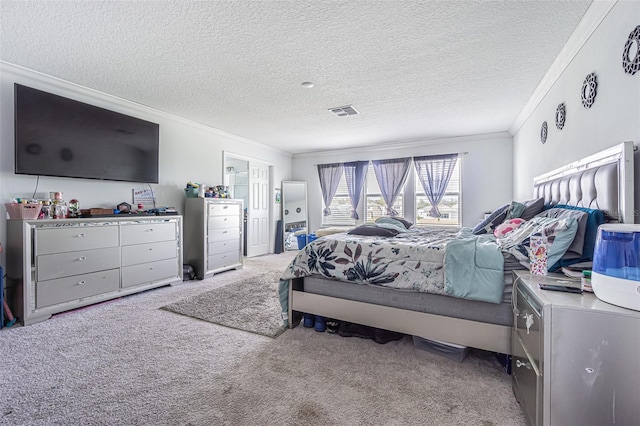 carpeted bedroom with a textured ceiling and ornamental molding