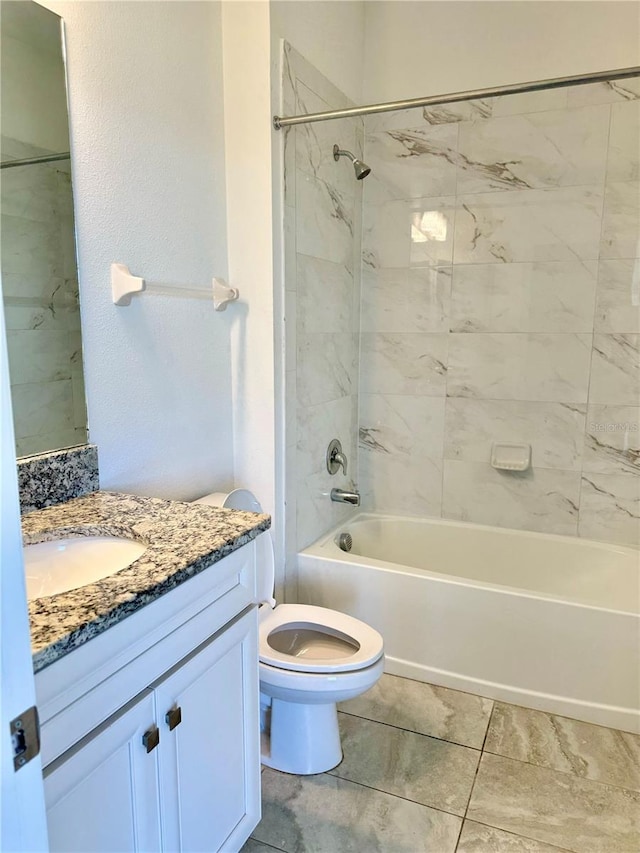 full bathroom with tile patterned flooring, toilet, vanity, and tiled shower / bath