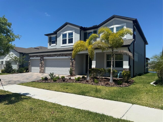 view of front of home featuring a front lawn and a garage