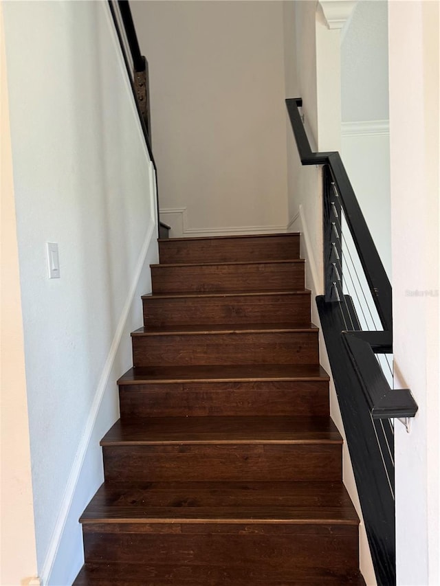 stairs featuring wood-type flooring