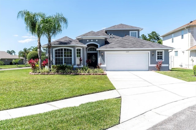 view of property featuring a front yard and a garage