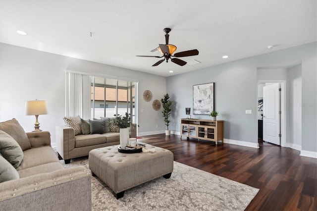 living room with ceiling fan and dark wood-type flooring