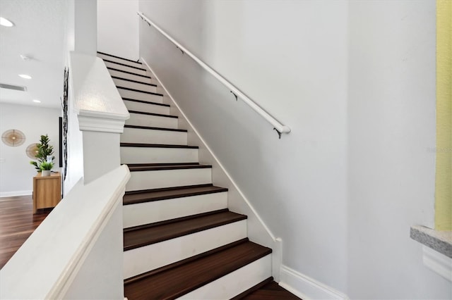 stairs featuring dark wood-type flooring