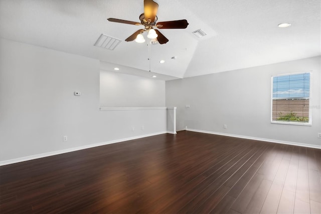 spare room featuring vaulted ceiling, ceiling fan, and dark hardwood / wood-style floors