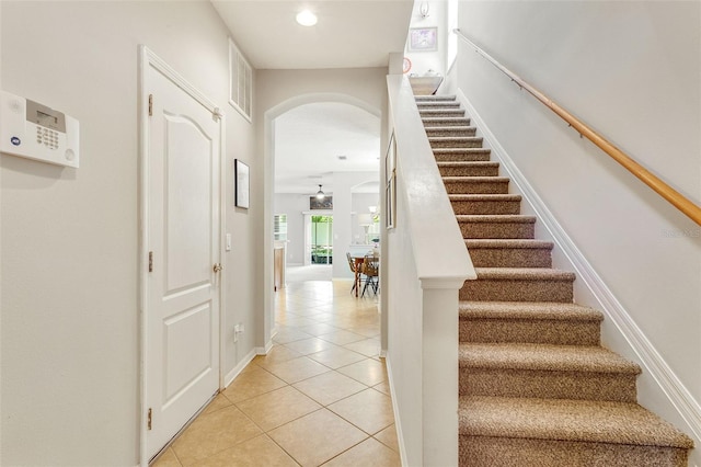 staircase with light tile flooring