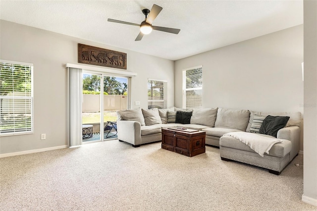 carpeted living room featuring ceiling fan