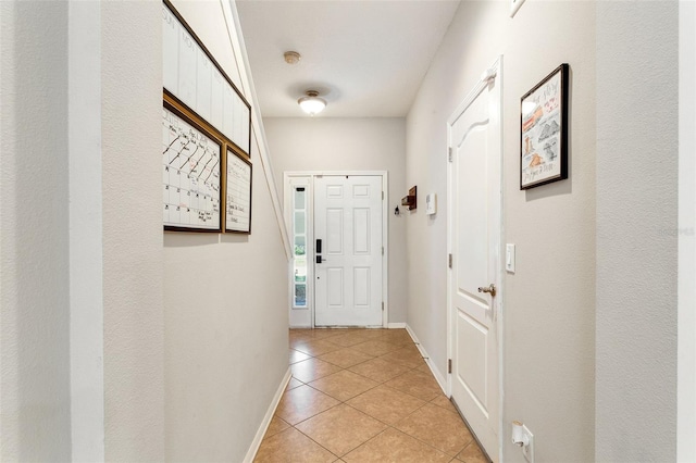 doorway to outside featuring light tile floors