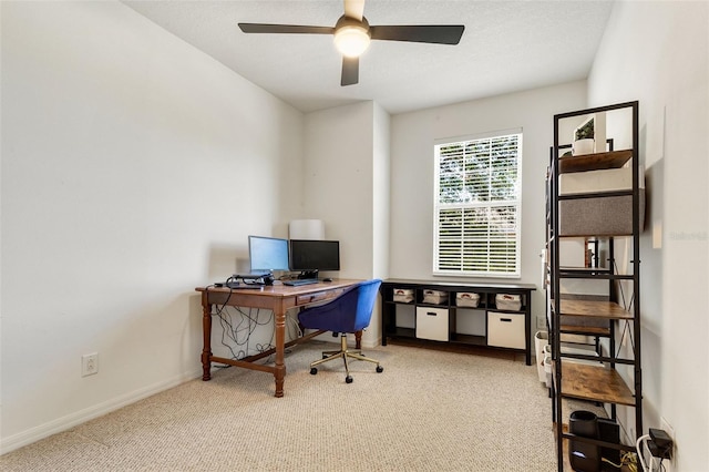 carpeted home office with ceiling fan