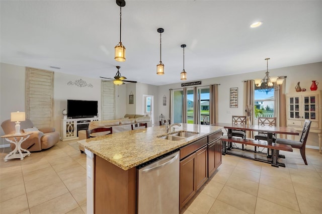 kitchen with pendant lighting, dishwasher, light tile floors, and sink