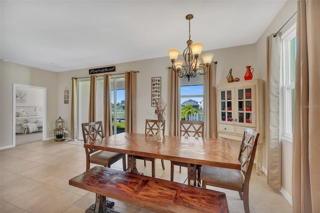 tiled dining area with a notable chandelier