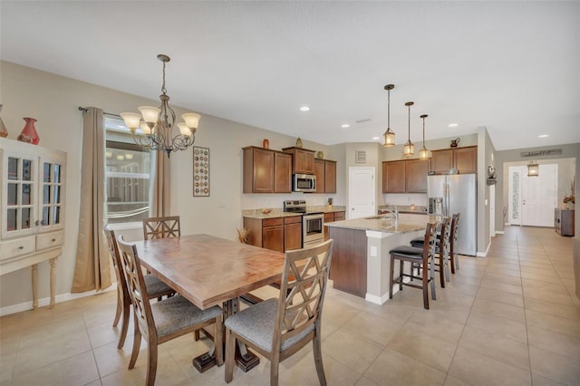 dining space with an inviting chandelier and light tile floors