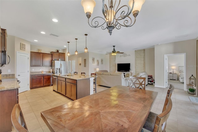 dining area featuring ceiling fan with notable chandelier and light tile floors