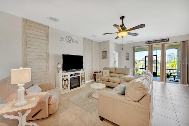 tiled living room featuring ceiling fan