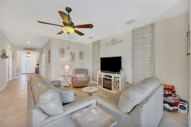 living room with ceiling fan and light tile floors