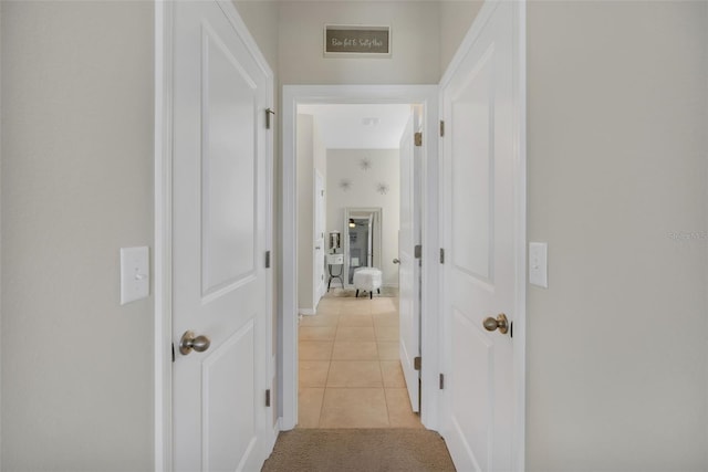 hallway featuring light tile floors