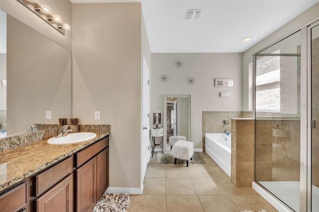 bathroom featuring plus walk in shower, tile flooring, and large vanity