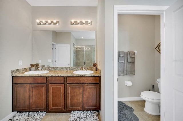 bathroom with oversized vanity, tile floors, toilet, and double sink