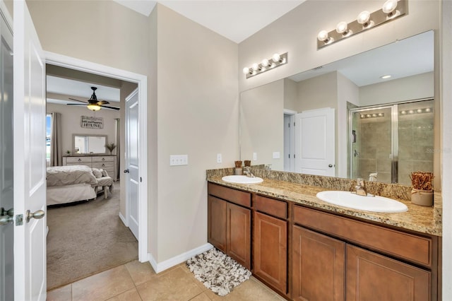 bathroom with a shower with door, double vanity, ceiling fan, and tile floors